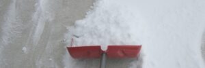 shoveling concrete driveway in winter